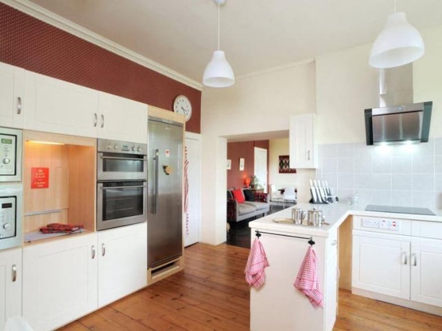 The bright kitchen has a modern feel, with fitted units and integrated appliances, along with a snug and breakfast room adjacent.