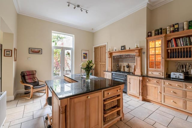 The spacious kitchen is full of country charm and contains a range of appliances.