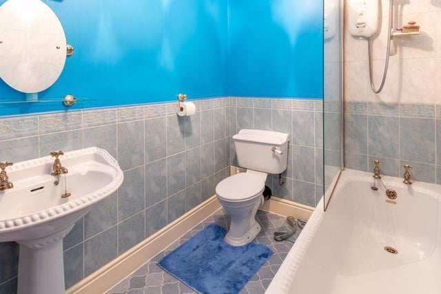 The property contains five bathrooms or shower rooms in total. Here is one of them, comprising bath with shower over, WC and wash hand basin..