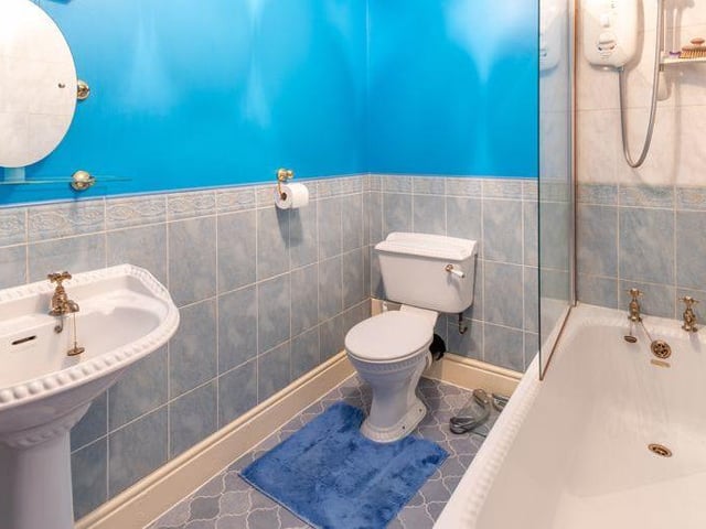 The property contains five bathrooms or shower rooms in total. Here is one of them, comprising bath with shower over, WC and wash hand basin..