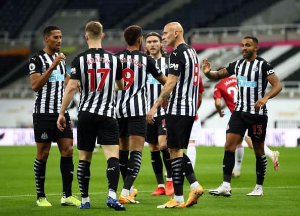 Newcastle players celebrate after Manchester United's English defender Luke Shaw (unseen scored an own goal during the English Premier League football match between Newcastle United and Manchester United at St James' Park in Newcastle-upon-Tyne, north east England on October 17, 2020.
