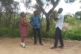 Zimbabwean residents Daition and Emmanual recording video footage.