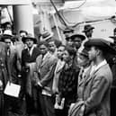 People from the Caribbean who answered Britain's call to help fill post-war labour shortages being welcomed by RAF officials from the Colonial Office after the ex-troopship HMT Empire Windrush landed them at Tilbury. PA Wire
