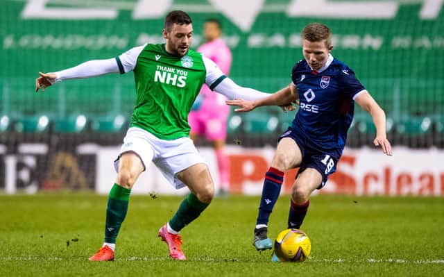 Hibs' Drey Wright and Ros County's Stephen Kelly battle for possession