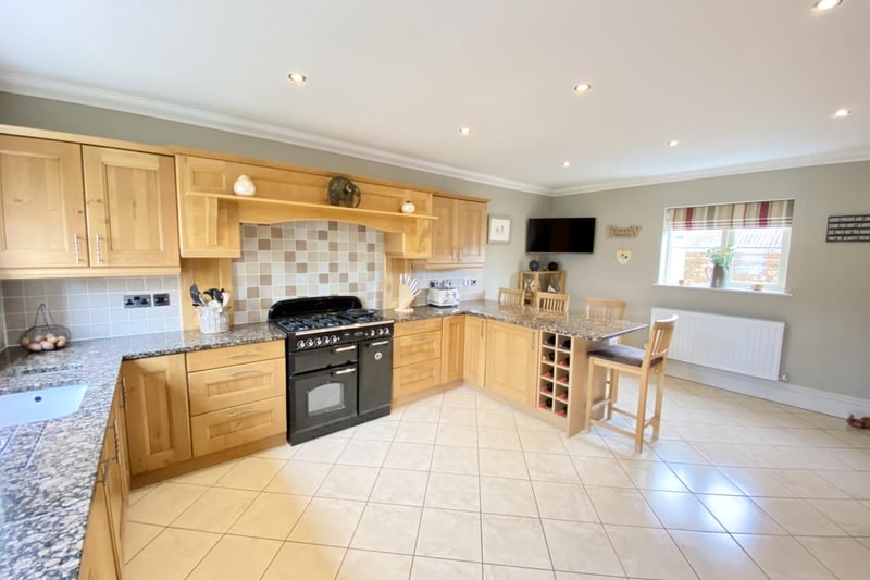 A cottage-style, fitted kitchen with an extensive range of matching base and eye level units, Granite worktop space, inset 1.5 sink unit and mixer tap, fitted wine rack, tiled surround, integrated dishwasher and larder fridge and freezer. Two glazed display units with additional basket store and worktop, gas connecting point and space for a Range-style cooker with fitted extractor hood over with down lighting and unit lighting.