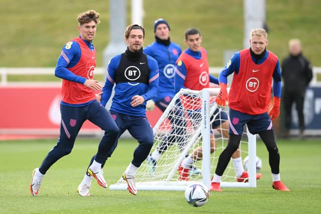 John Stones, Jack Grealish and Aaron Ramsdale watch a loose ball during a training session at St Georges Park on October 05, 2021 in Burton-upon-Trent, England. (Photo by Michael Regan/Getty Images)