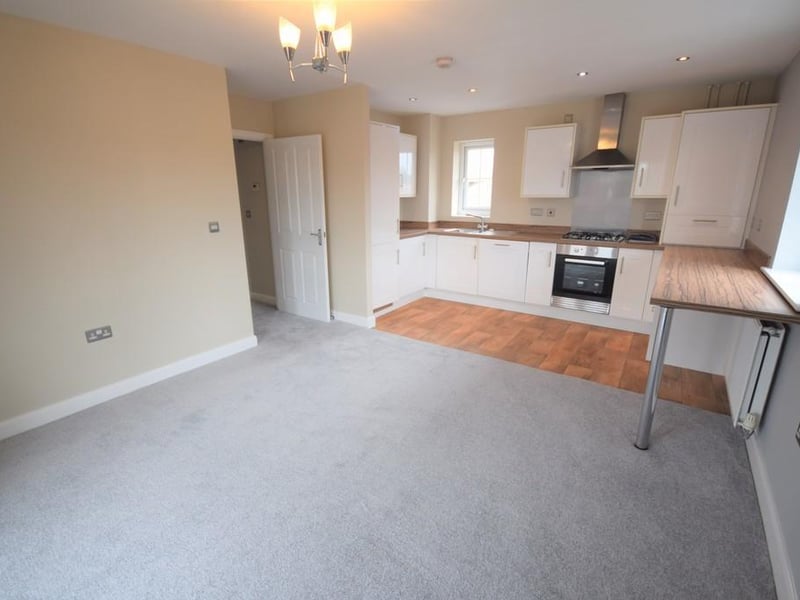 A fabulous open plan kitchen/living area providing plenty of natural light through from the UPVC windows and balcony doors. The kitchen area has an extensive range of high gloss units with contrasting worktops incorporating a handy breakfast bar. The kitchen has a stainless steel electric oven and hob with splashback and complimentary hood over. There are numerous integrated appliances including the fridge freezer, dishwasher, Electrolux washing machine, concealed Ideal Logic boiler, a host of stainless steel socket points, two radiators, wood effect lino flooring, new contemporary grey carpet and a south facing balcony to sit and relax with afternoon and evening sun aspect.