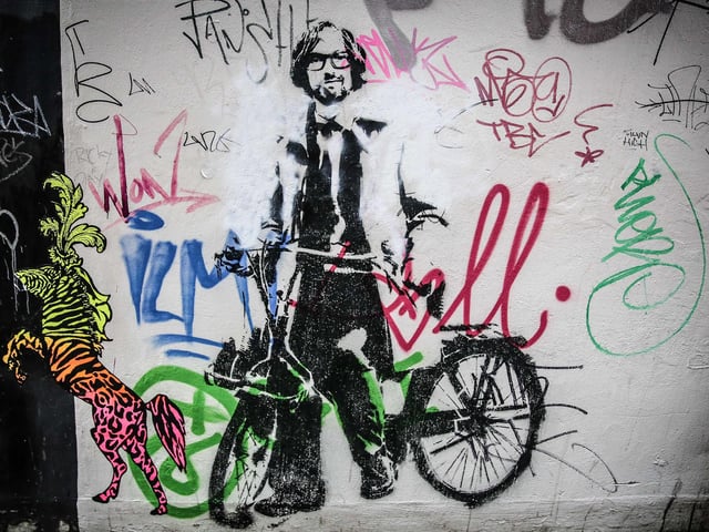 A 'Banksy style' stencil of Pulp frontman Jarvis Cocker riding a bike near the Workstation, Sheffield in June 2014. The artist Stewy, based in Bristol, had permission to create the works of art from property owners in West and South Yorkshire in the build-up to the Tour de France Grand Depart
