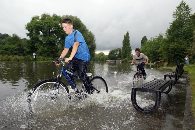 Michael Kelly & William Clayton made the most of the un-seasonal weather after the River Don & ajoining canal merged in flood at Sprotbrough Falls, Doncaster in 2004