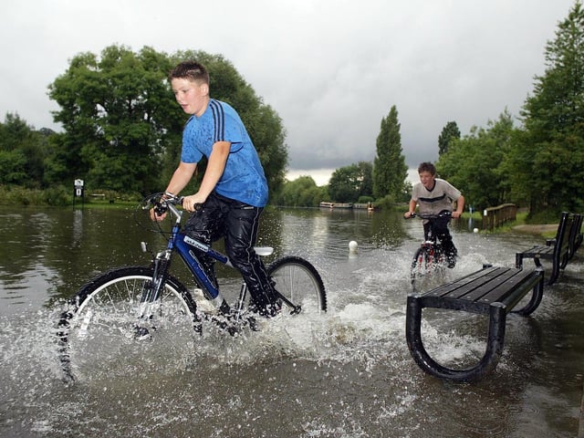 Michael Kelly & William Clayton made the most of the un-seasonal weather after the River Don & ajoining canal merged in flood at Sprotbrough Falls, Doncaster in 2004