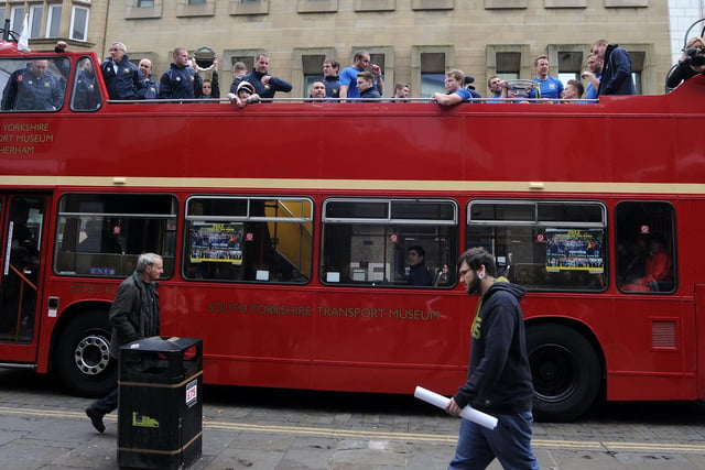Dons' open top bus parade makes its way through town.