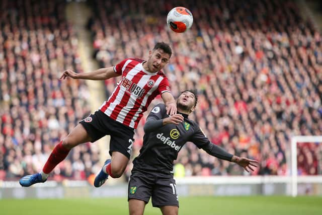 George Baldock of Sheffield United and Onel Hernandez of Norwich City during the last Premier League match at Bramall Lane before the fixture calendar was suspended: Alistair Langham/Sportimage