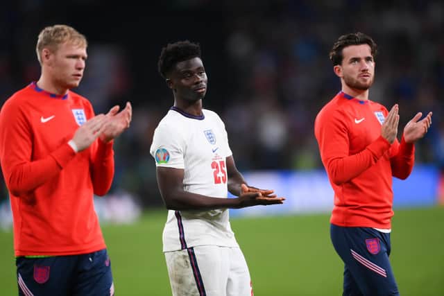 LONDON, ENGLAND - JULY 11: Aaron Ramsdale, Bukayo Saka and Ben Chilwell of England look dejected as they applaud fans after the UEFA Euro 2020 Championship Final between Italy and England at Wembley Stadium on July 11, 2021 in London, England. (Photo by Laurence Griffiths/Getty Images)