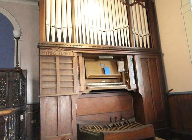 Here's the church organ, complete with its wooden board for displaying hymn numbers.