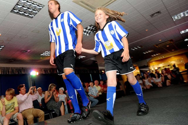 Owls players on the catwalk along with John Lewis staff modelling the new kit for the forthcoming season in July 2009. Pictured, Mark Beevers with a young fan