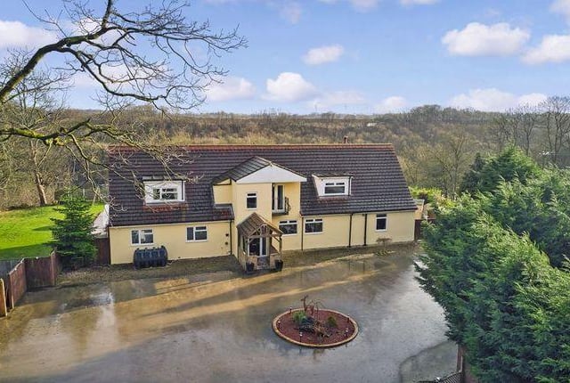 This five bedroom house has about 6.5 acres of private woodlands, views over went valley and an outdoor pool.