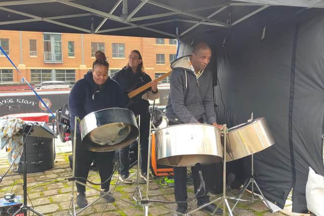 Musicians set the scene at Victoria Quays to welcome families ahead of Little Amal's arrival.