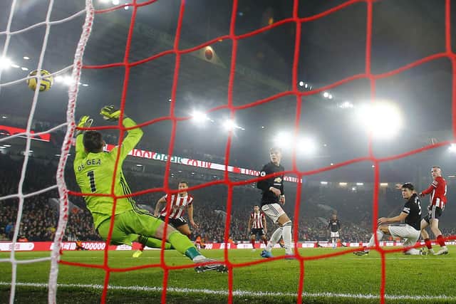 Oli McBurnie of Sheffield United scores his teams third goal against Manchester United during the Premier League match at Bramall Lane, Sheffield: Darren Staples/Sportimage