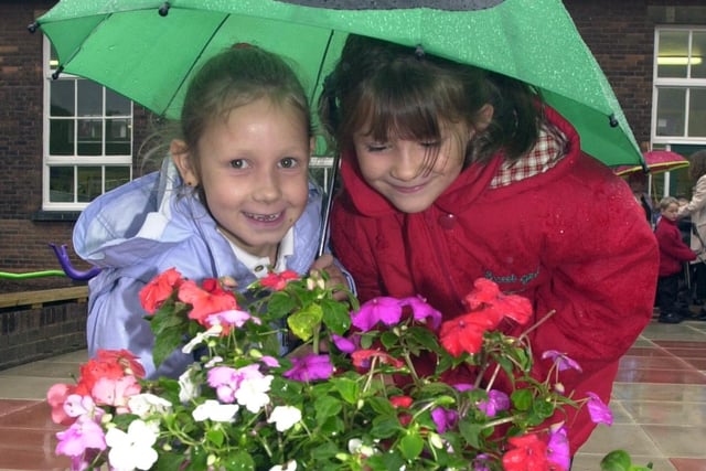 Owston Skellow School pupils Sarah Baker and Katie Edwardson, both aged six, admire some of the flowers in the garden