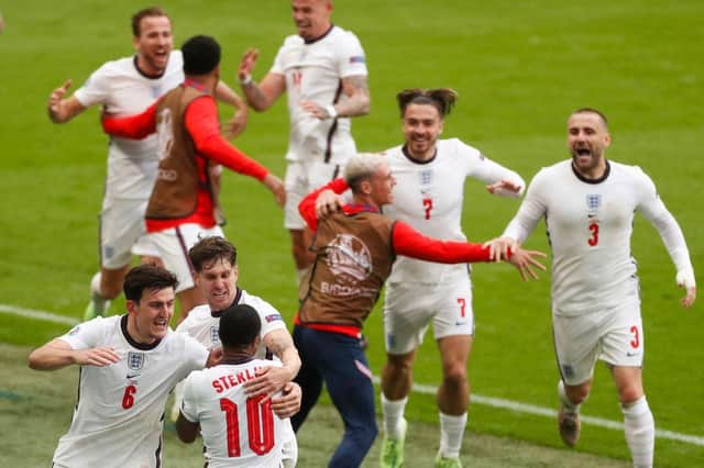 England's players celebrate Raheem Sterling's opening goal against Germany. Photo by MATTHEW CHILDS/POOL/AFP via Getty Images