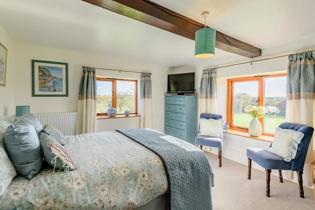 Another superb bedroom with a beamed ceiling and pleasant views overlooking the countryside that surrounds the £895,000 Warsop Vale property.