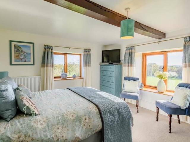 Another superb bedroom with a beamed ceiling and pleasant views overlooking the countryside that surrounds the £895,000 Warsop Vale property.