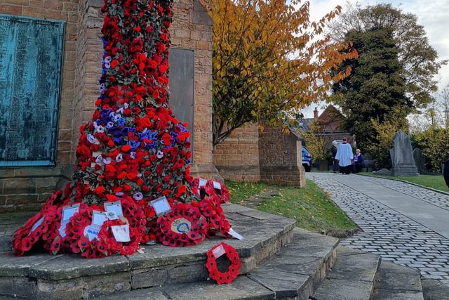 Wreaths and poppies on the war memorial outside St Mary' Church in Bulwell