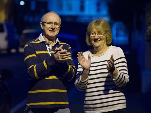 Martin and Teresa Rowe outside their home in Southsea take part in Clap for Carers.