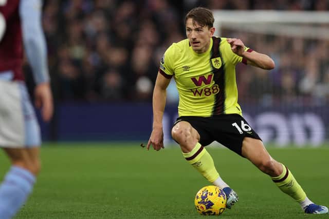 Burnley's Norwegian midfielder #16 Sander Berge runs with the ball during the English Premier League football match between Aston Villa and Burnley at Villa Park in Birmingham, central England on December 30, 2023. (Photo by Adrian DENNIS / AFP) / RESTRICTED TO EDITORIAL USE.
