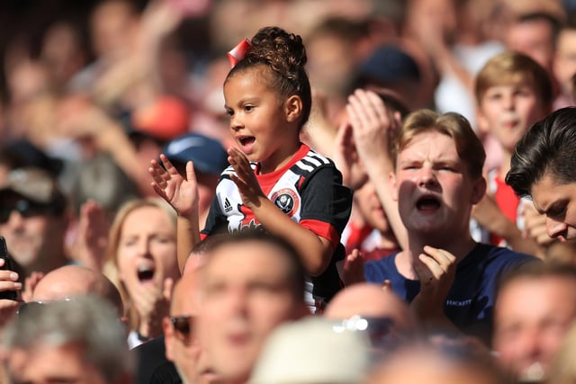 A young United fan cheers on her side during the Sky Bet Championship match against Swansea City at Bramall Lane in August 2018.