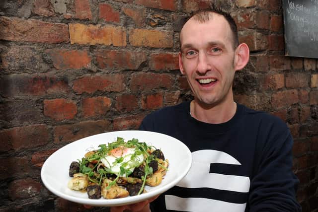 Jonty Cork holds up a wild mushroom, black pudding and new potato hash with a fried egg dish at Made By Jonty, Sharrow Vale Road.