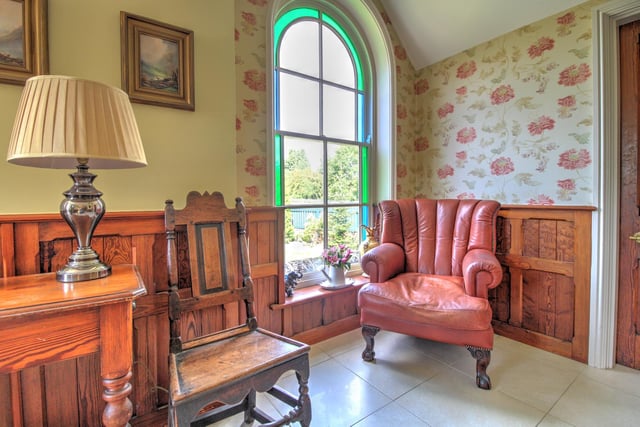 The owner has defined this sitting area a reading chairs "enhanced" with an arched stained glass window.