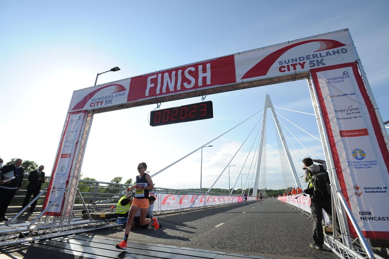 Sunderland's Aly Dixon crosses the finish of the City Runs 5k on the Northern Spire Bridge.