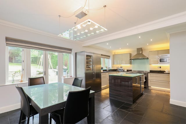 This fully integrated kitchen has a range cooker and French doors onto the garden.