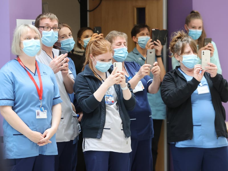 NHS staff take photos on their mobile phones as the royal couple officially open The Balfour, Orkney's new hospital in Kirkwall.