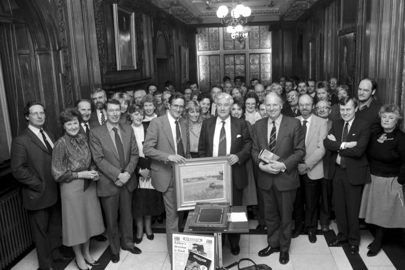 Scotsman Publications staff gather to present former Scotsman editor Eric B Mackay with his retiral gift in the Walnut Hall at North Bridge Edinburgh, November 1985. Editor Chris Baur (glasses) gives Mr Mackay a painting.