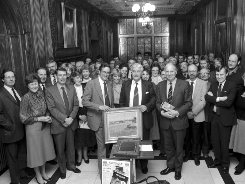 Scotsman Publications staff gather to present former Scotsman editor Eric B Mackay with his retiral gift in the Walnut Hall at North Bridge Edinburgh, November 1985. Editor Chris Baur (glasses) gives Mr Mackay a painting.