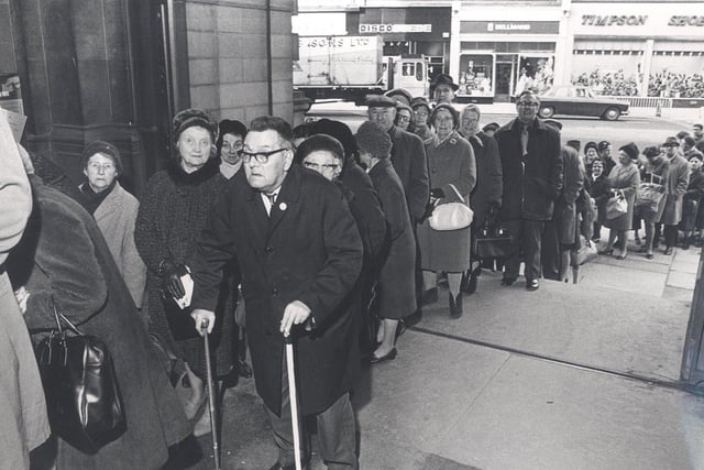 Pensioners waiting patiently for alarm buzzers at Sheffield Town Hall, in February 1971