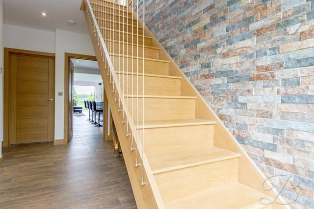 A "welcoming" reception hallway with a solid oak staircase rising to the first floor accommodation, central heating radiator and ceiling inset led spotlights.