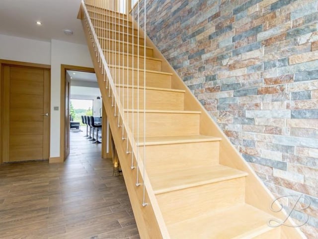 A "welcoming" reception hallway with a solid oak staircase rising to the first floor accommodation, central heating radiator and ceiling inset led spotlights.