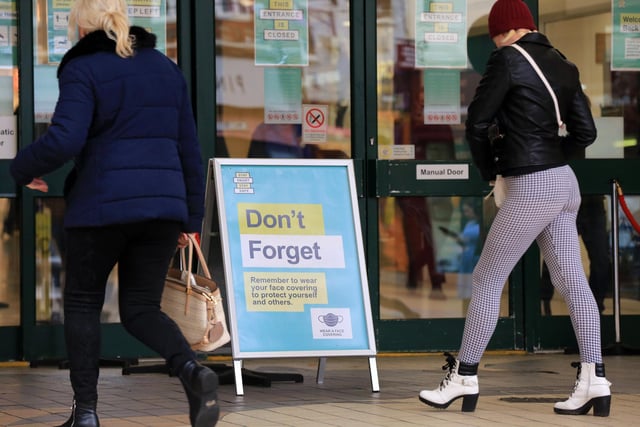 Signs reminding shoppers to wear face coverings