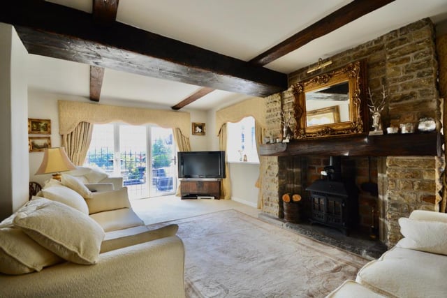 The living room has a log burning stove and bi-folding doors to the patio.