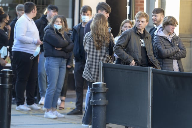 Drinkers queue outside a Wetherspoons