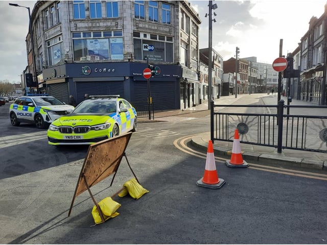 Police guard the entrance to Silver Street and Sunny Bar.