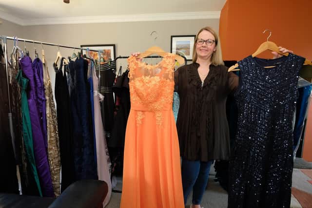 Charlotte Driver with some of the prom dresses that will be sold cheap at the fundraising event.
