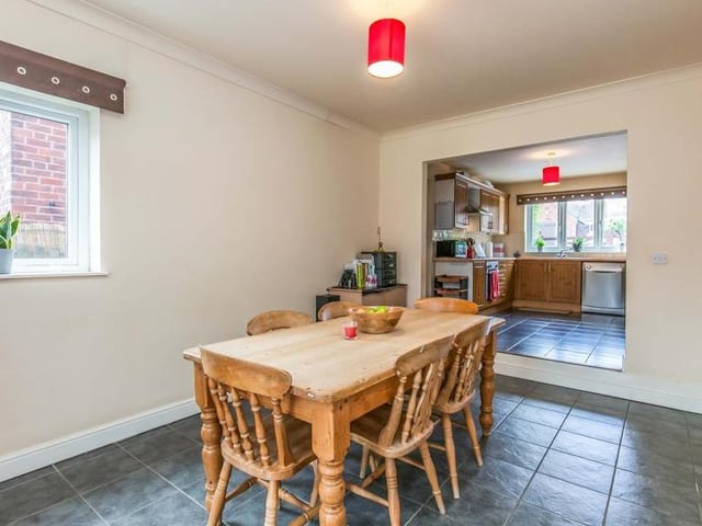 This dining area, just off the kitchen (background), boasts a ceramic tiled floor, coving to the ceiling and double-glazed window. There is ample space for a bigger dining table.