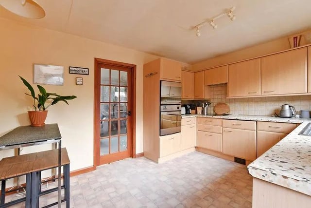 The kitchen is actually quite large. It overlooks the garden and has a large window, making it very bright when the sun works its way in.