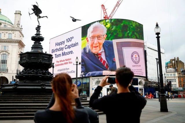 A birthday message for Captain Tom Moore is displayed on the advertising boards in Piccadilly Circus in London on April 30, 2020 as the country celebrates his 100th birthday. (Photo by Tolga Akmen / AFP)