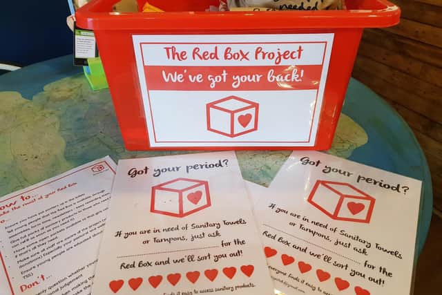 Red boxes containing sanitary products and other items are placed in schools and other venues to tackle period poverty in Wigan