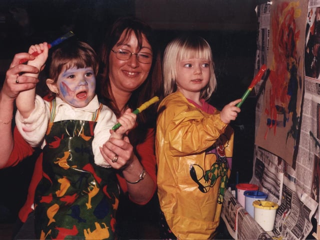 Doing a spot of 'cave painting' at  Crags Pre-School Playgroup was  Dana Marie Hunt, Maria Marsh (play leader) and Grace Unwin in 2001